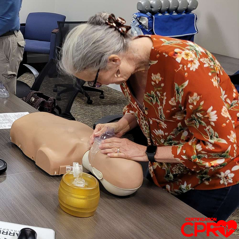 CPR training session with adult mannequin in Austin.